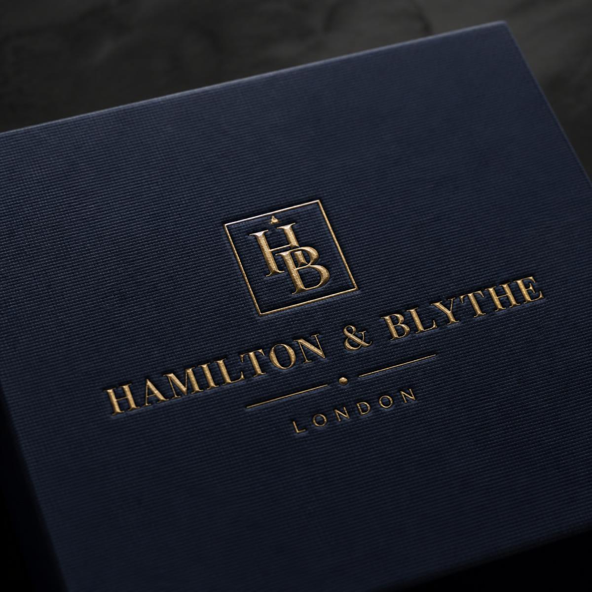 Close-up of gold foil debossed logo on the navy textured kit lid